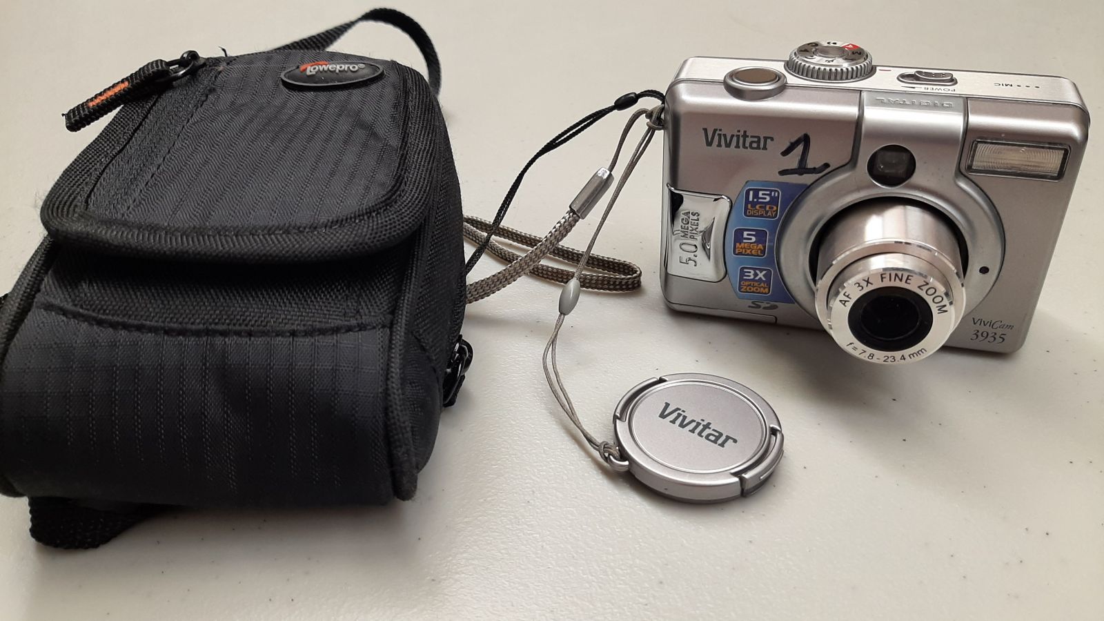 An image of a digital camera with a case.