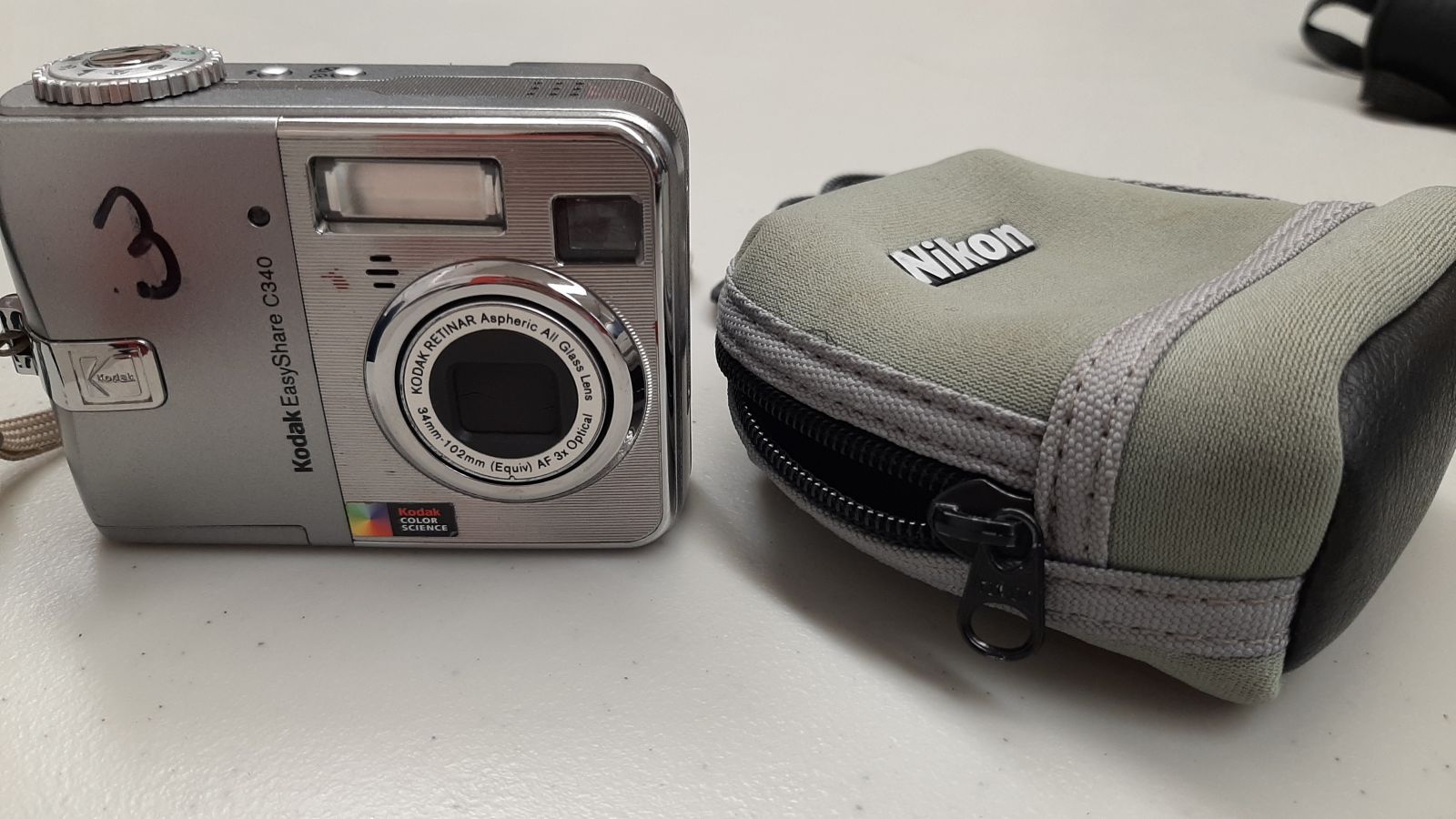 An image of a digital camera with a case.