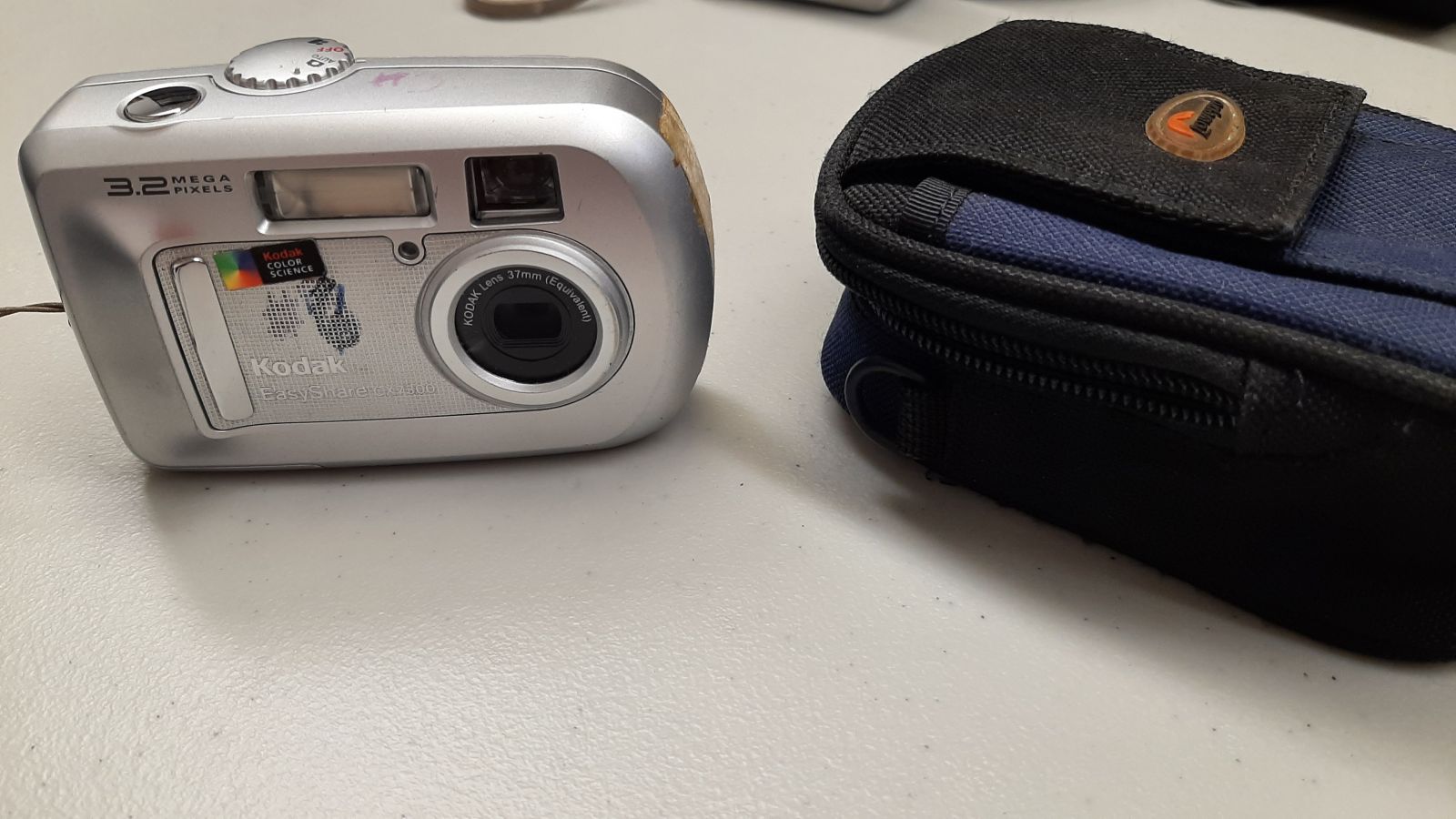 An image of a digital camera and case.