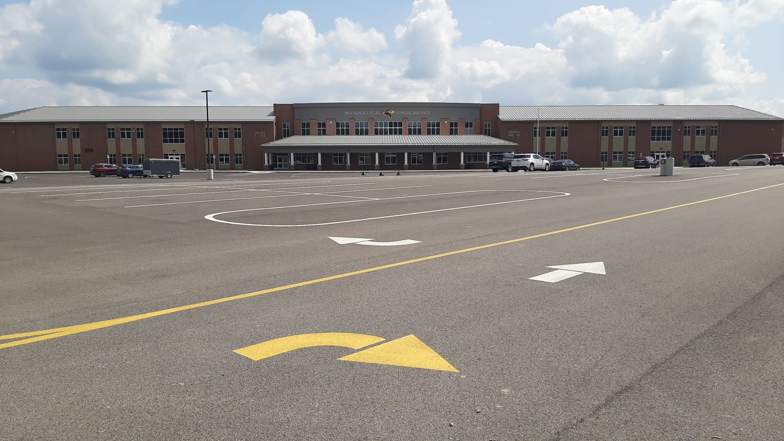 An image of yellow and white arrows in the parking lot.   