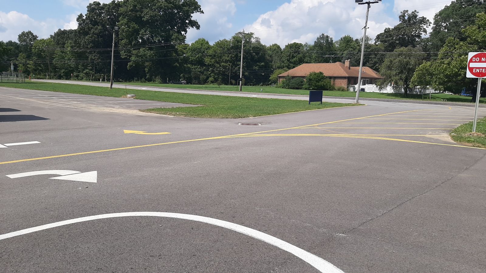 An image of the parking lot, signage, and painted lines on the blacktop.