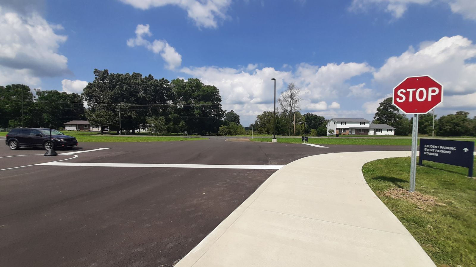 An image of the parking lot, signage, and painted lines on the blacktop.