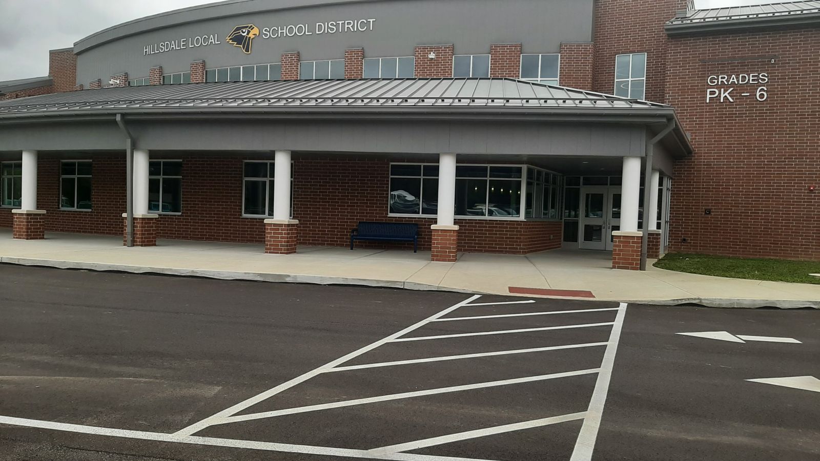 An image of the PK-6 side of the building with the crosswalk painted on the parking lot surface.