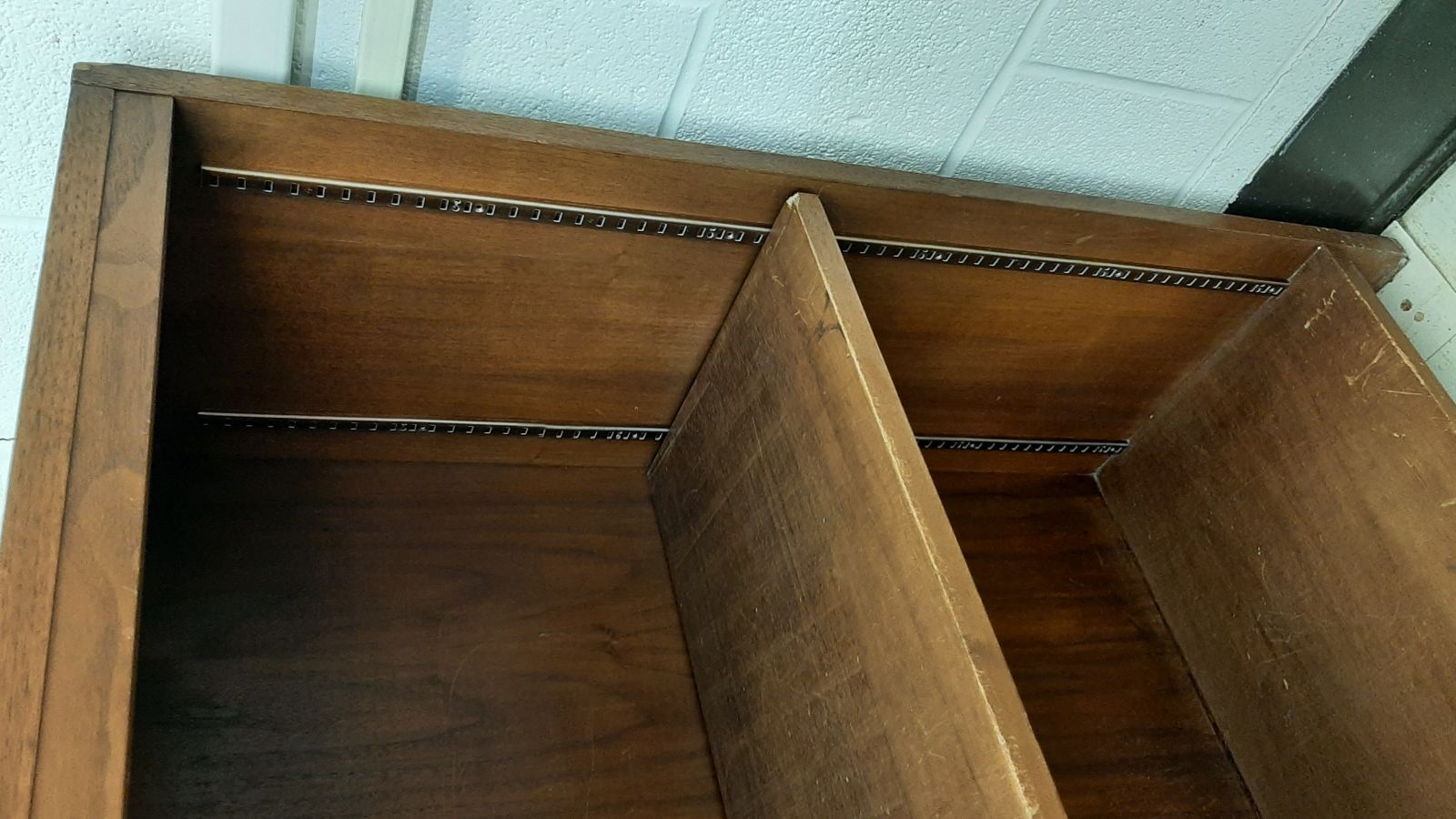 An image of the side of a two-shelf-wood bookcase.