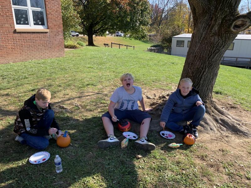 Students paint pumpkins.