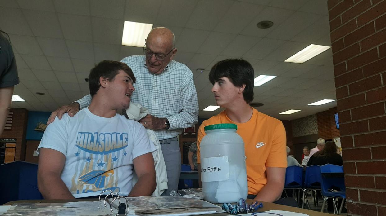 Students talk with a senior citizen.