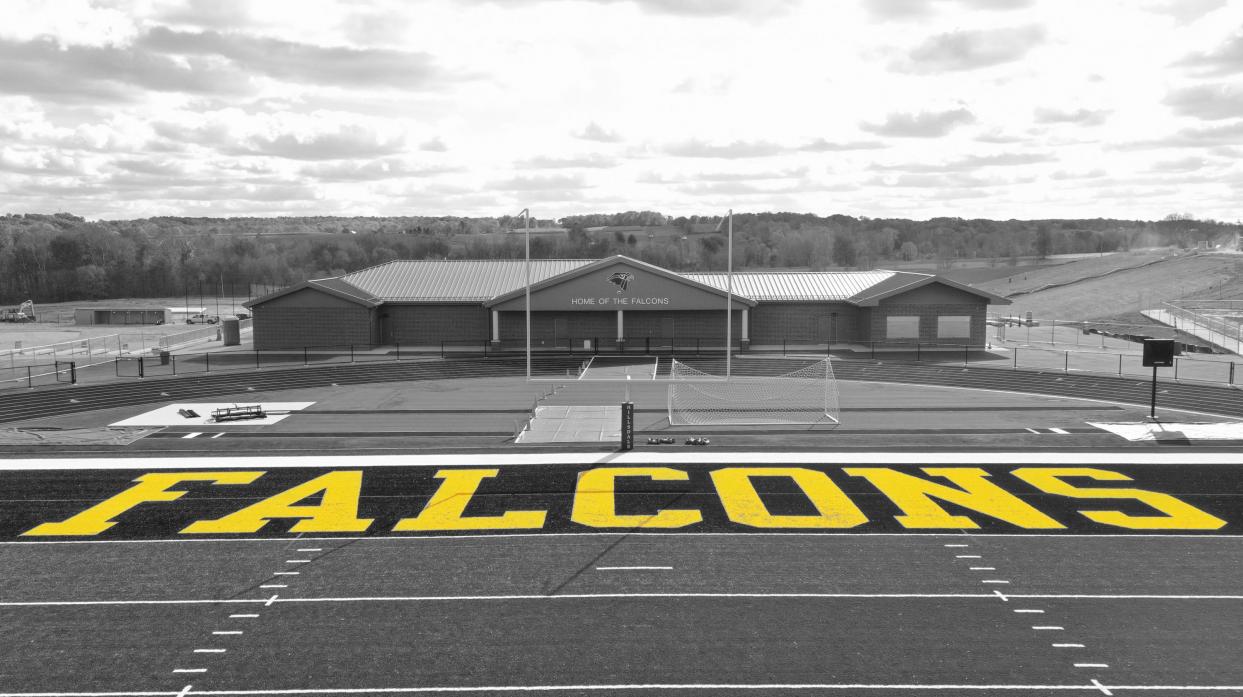 The south end zone with "FALCONS" is pictured along with the front of the field house.