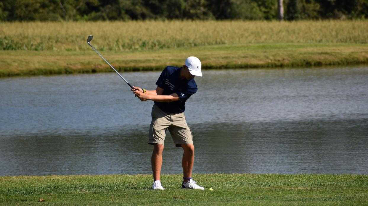 An image of a golfer teeing off.