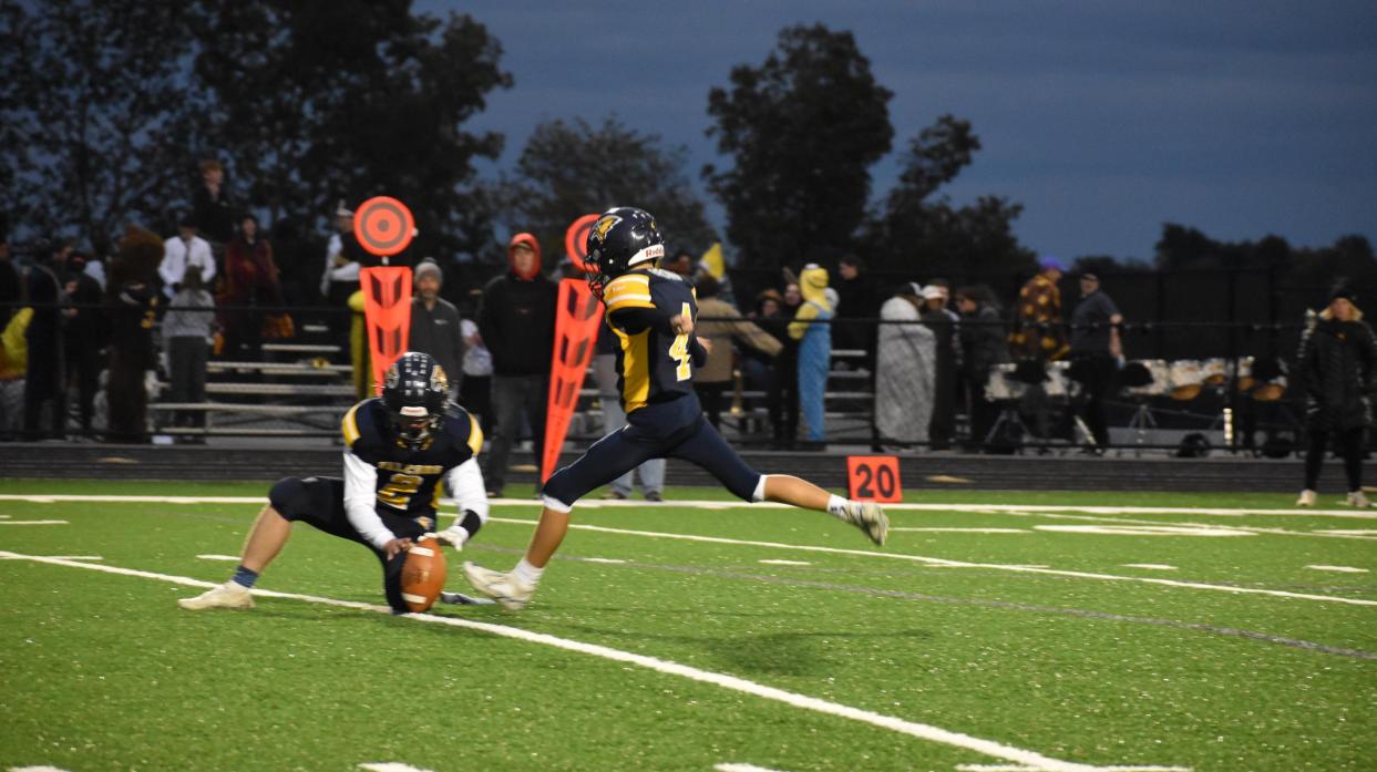 The kicker kicks for the extra point following a touchdown during the varsity football game.