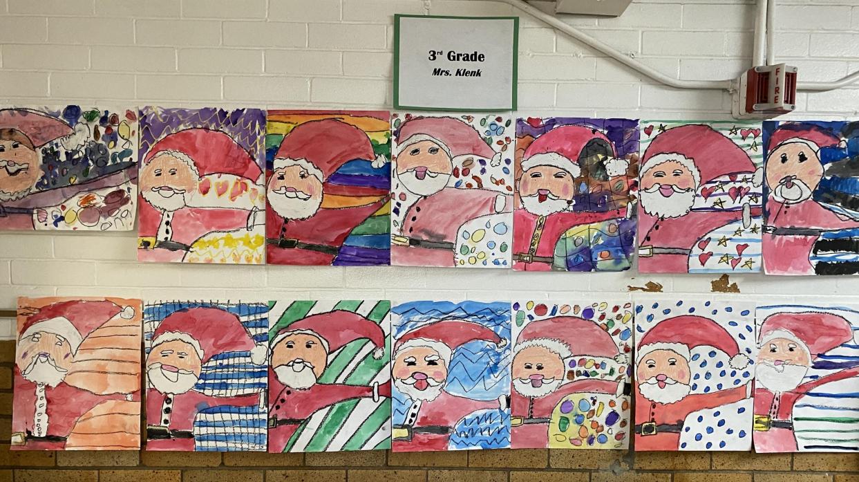 Santa Claus paintings; text on placard on wall: "Third-Grade Mrs. Klenk:
