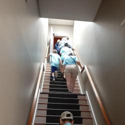 A photo of students ascending a very long stairwell 