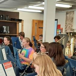 Band students are instructed by director Mr. Allen Terwilliger in the classroom.