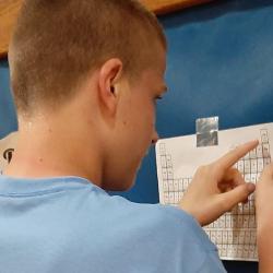 A student looks at a copy of the Periodic Table.