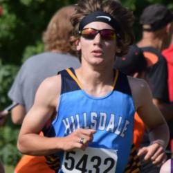 An image of an athlete running the cross country trail.