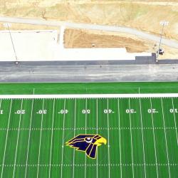 an overhead drone shot of the completed football field laid with turf and the newly asphalted  track
