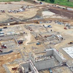 an overhead drone shot showing a majority of the construction site with the asphalt visible that had been added this week