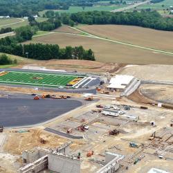 a higher overhead drone shot of the complete construction site with the asphalt visible that had been added this week