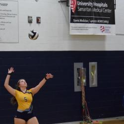 Student-athlete serves ball during volleyball game