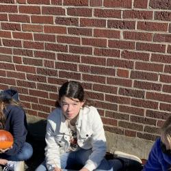 Students paint pumpkins.