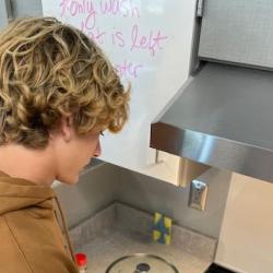 An image of a student cooking on the stovetop.