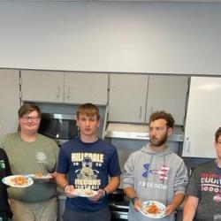 An image of students holding plates of food.