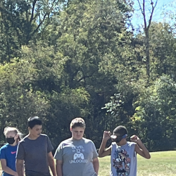 Students stand in a team group, one wearing goggles.