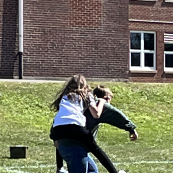 Students participate in the piggyback relay.