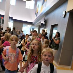 An image of students walking in the hallway.
