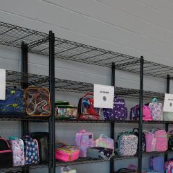 An image of lunchboxes on shelving units sorted by grade.