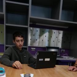 A student watches a finchbot move through the coded commands.