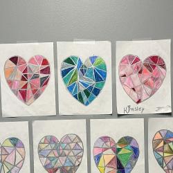 An image of heart artwork displayed on a hallway wall.