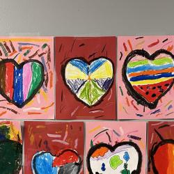 An image of heart artwork displayed on a hallway wall.