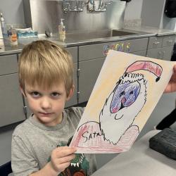A student shows off his Santa artwork.