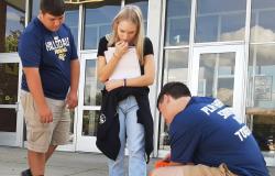 Students measure the radius of the chalk circle.