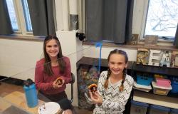Students hold up their completed Oreo turkeys.