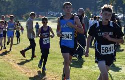 An image of an athlete running the cross country trail.