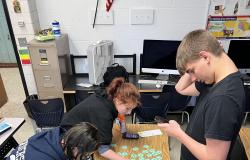 Students work on placing the hexagonal pieces together.